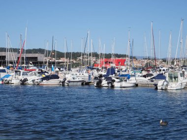 İspanya 'nın Pontevedra kentindeki Avrupa balıkçı köyündeki yat ve teknelere panoramik manzara, Eylül' de güneş batarken 2019 'da açık mavi gökyüzü.