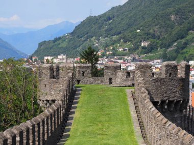 Stony flanking of castel grande in european Bellinzona city, capital of canton Ticino in Switzerland, clear blue sky in 2017 warm sunny summer day on July.