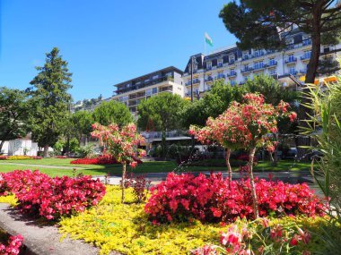MONTREUX, SWitness ZERLAND HAZİRAN 2017: Grand Hotel Suisse Majestic ve Canton Vaud 'daki Avrupa şehrinde çiçekler, güneşli yaz gününde açık mavi gökyüzü.