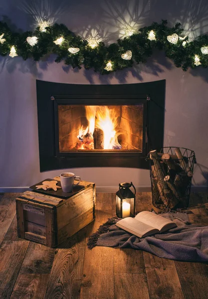 Cozy interior with vintage lamp, book and Christmas decoration near fireplace