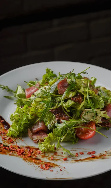 Insalata vegetale su un piatto su uno sfondo di vetro — Foto Stock