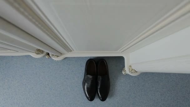 Чорне взуття стоїть на підлозі — стокове відео