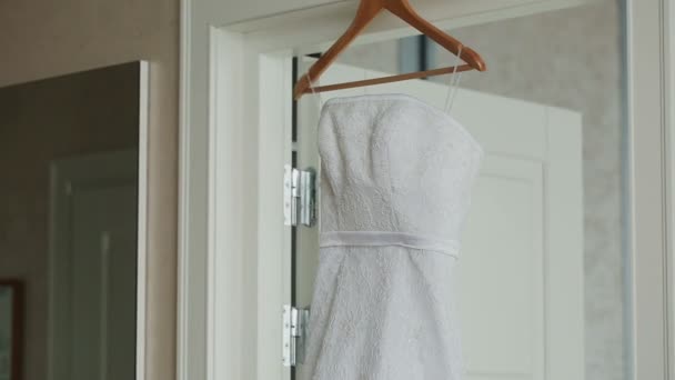 Wedding dress hanging in a white beautiful room — Stock Video