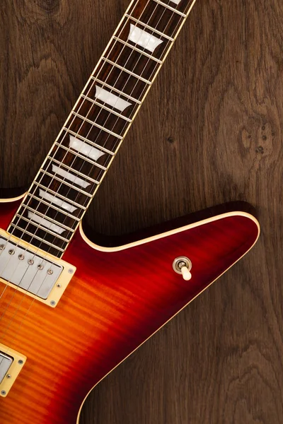 Old beautiful electric guitar on a background of wood. — Stock Photo, Image