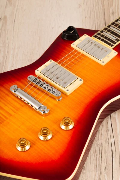 Old beautiful electric guitar on a background of wood. — Stock Photo, Image