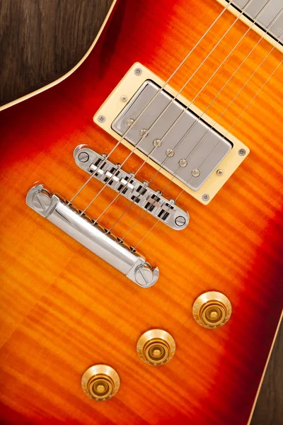 Old beautiful electric guitar on a background of wood. — Stock Photo, Image