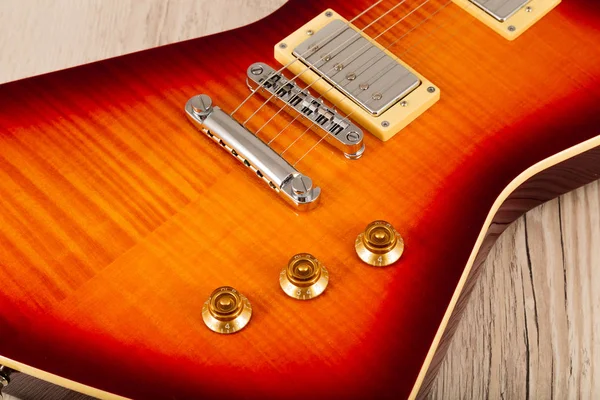 Old beautiful electric guitar on a background of wood. — Stock Photo, Image