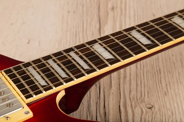 Old beautiful electric guitar on a background of wood. — Stock Photo, Image