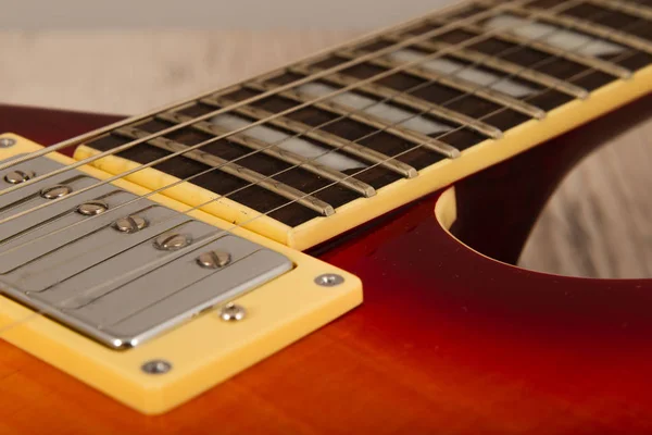 Old beautiful electric guitar on a background of wood. — Stock Photo, Image