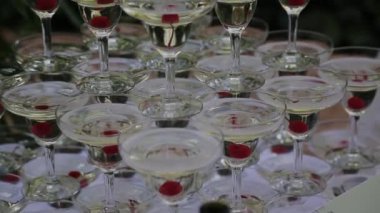 Konuklar eller köpüren şarap gözlükle partisinde al. Gözlük Piramitleri inşa edilir. Hiçbir tanınabilir kişi.