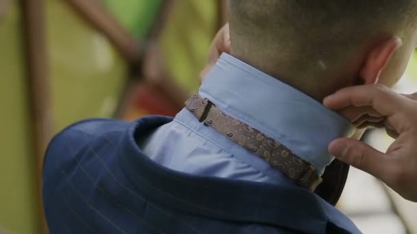 A picture of a groom fixing a fine tie carefully, neat white shirt on — Stock Video