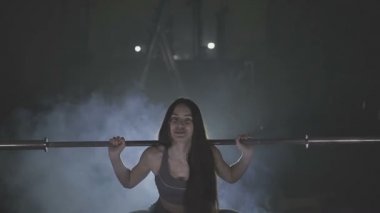 Tam boy görüntü o ağız kavgası gibi bir halter onun omuzlarında ağır ağırlıklar ile tutarak onun gücü test genç bir kadın