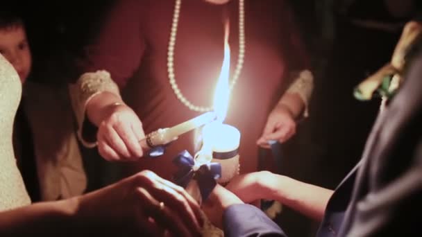 Parents light a candle at their childrens wedding — Stock Video