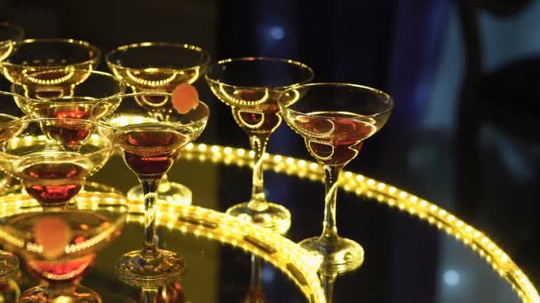 En vacker pyramid av glas med champagne och bitar av frukt i det — Stockvideo