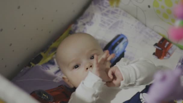 Happy newborn baby yawns closeup in white bed — Stock Video