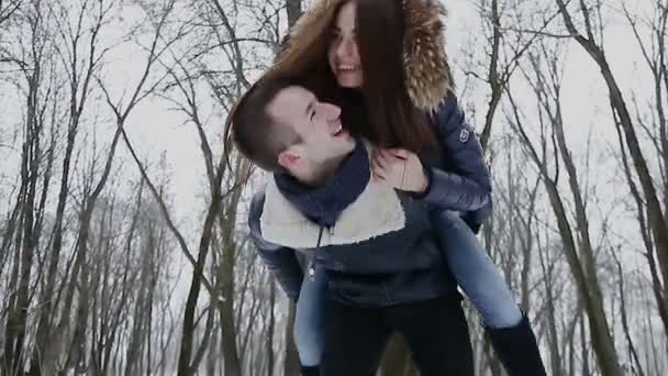 Парень и девушка зимой в парке — стоковое видео