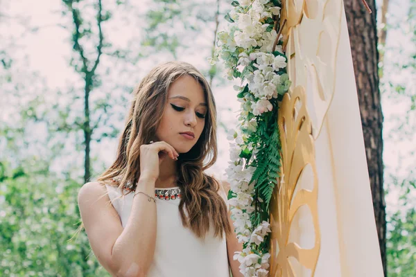 Zeer mooie vrouw in de natuur omgeven door echte bloemen. — Stockfoto