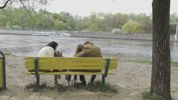 Family walks on the river bank in warm weather — Stock Video