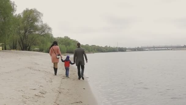 Familie wandelingen aan de rivieroever in warm weer — Stockvideo