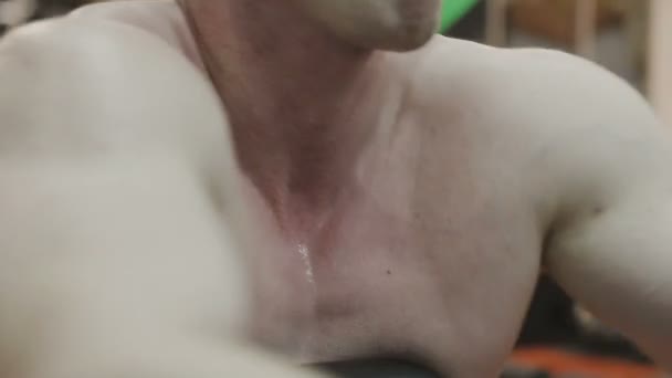 Muskularny mężczyzna z nagi tors pociągi na maszynie fitness w klubie fitness — Wideo stockowe