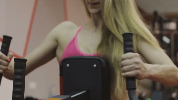 피트 니스 클럽에는 피트 니스 기계에 매우 아름 다운 여성 트레이너 열차 — 비디오