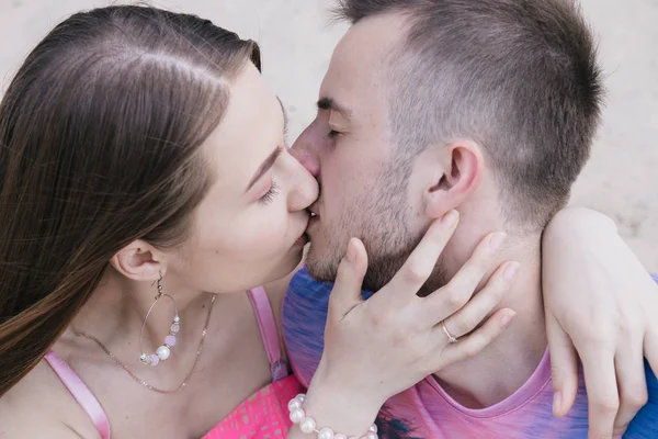 Young couple hugging and smiling at each other on the river bank. Walking along the sandy beach — Stock Photo, Image