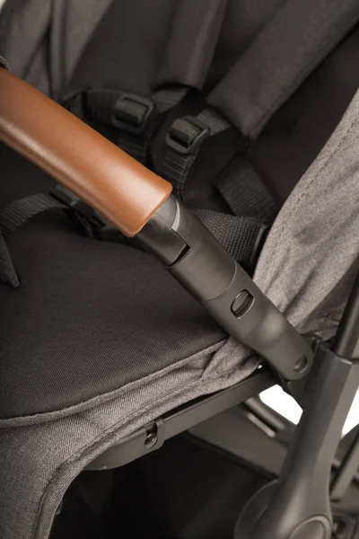 A stroller on a white background, details of a stroller close-up.