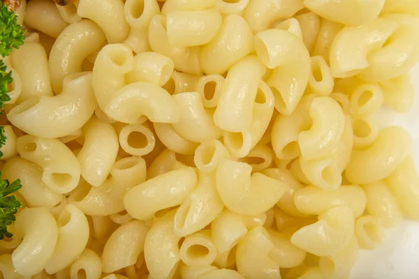 Boiled yellow pasta on a white plate. — Stock Photo, Image