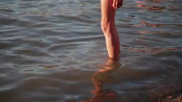 Human feet in sea water in the warm season. — Stock Video