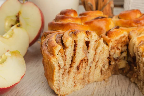 Kuchen mit Äpfeln und Zimt auf einem hölzernen Hintergrund mit Zutaten. — Stockfoto