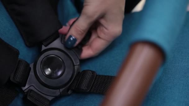 The process of folding a baby stroller in a childrens store on the camera. — Stock Video