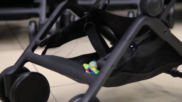 The process of folding a baby stroller in a childrens store on the camera. — Stock Video