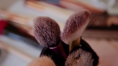 Masanın üzerinde büyük makyaj fırçaları.