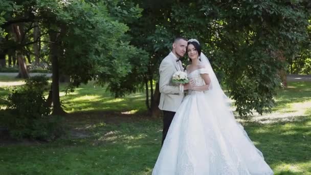 Новобрачные обнимаются и наслаждаются друг другом в день свадьбы . — стоковое видео