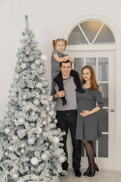 Família feliz e bela de três em um quarto de Ano Novo brilhante festivo . — Fotografia de Stock