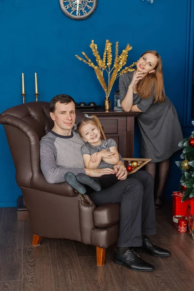 Very cheerful and beautiful family in the New Year room . — стоковое фото