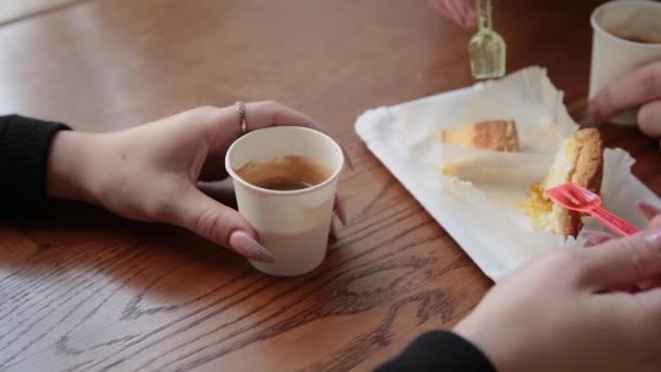 Love couple sitting in a cafe eating dessert drinking coffee and looking at each other. — Stock Video