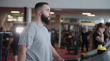 Spor salonunda treadmill egzersiz yakışıklı atletik erkek.