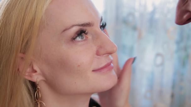 Truccatore preparare il viso di una bella donna prima di applicare il trucco . — Video Stock