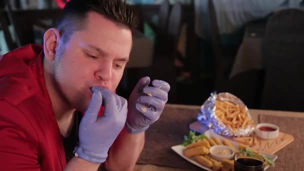 Man licking his hands after eating. — Stock Video