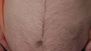 Şişman adam şişman karnına dokunmak.