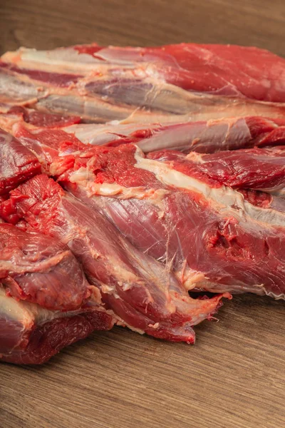 Rauwe vers rundvlees op een houten ondergrond, winkel. — Stockfoto
