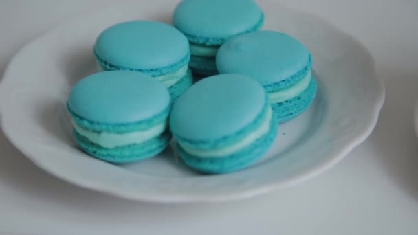 Fresh and tasty macaroons on a white plate. — Stock Video