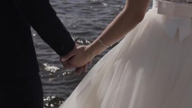 Evlen benimle bugün ve her gün. Yeni evli çift tutuşup, ağır çekimde atış.