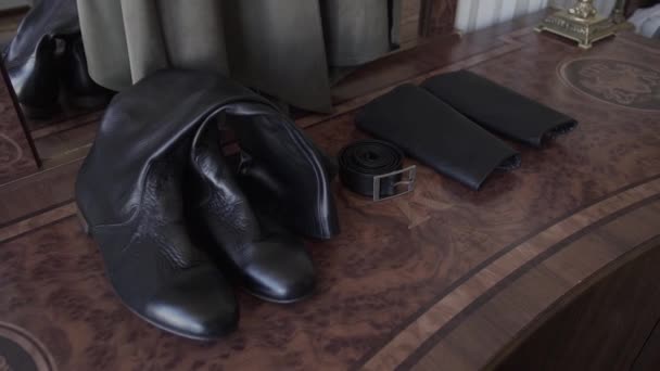 Kulit antik sepatu boot berdiri di meja samping tempat tidur dengan cermin . — Stok Video