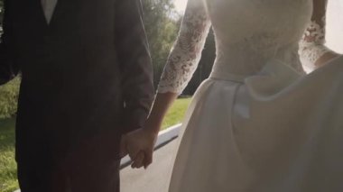 Evlen benimle bugün ve her gün. Yeni evli çift tutuşup, ağır çekimde atış.