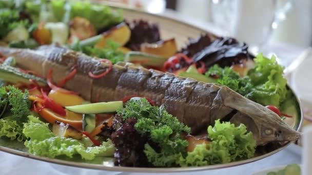Ein Gericht gebratener Stör auf einem Teller mit Gemüse. — Stockvideo