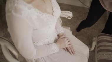 Güzel elleri genç bir kadın diz.