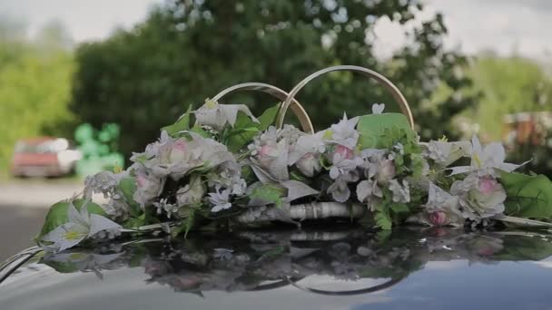 Wedding decorations and scenery in view golden rings by car roof. — Stock Video