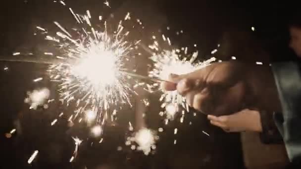 Sparklers burn at night, bright light. — Stock Video